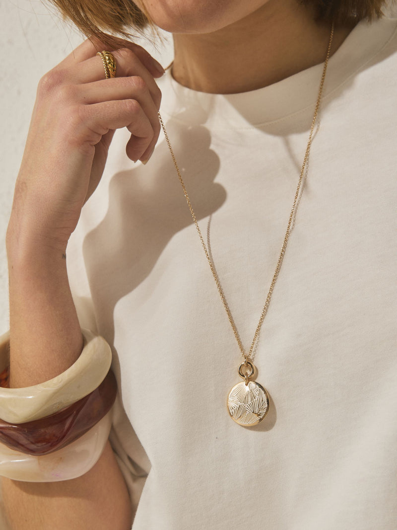Gold tone etched pendant necklace, imported from the UK