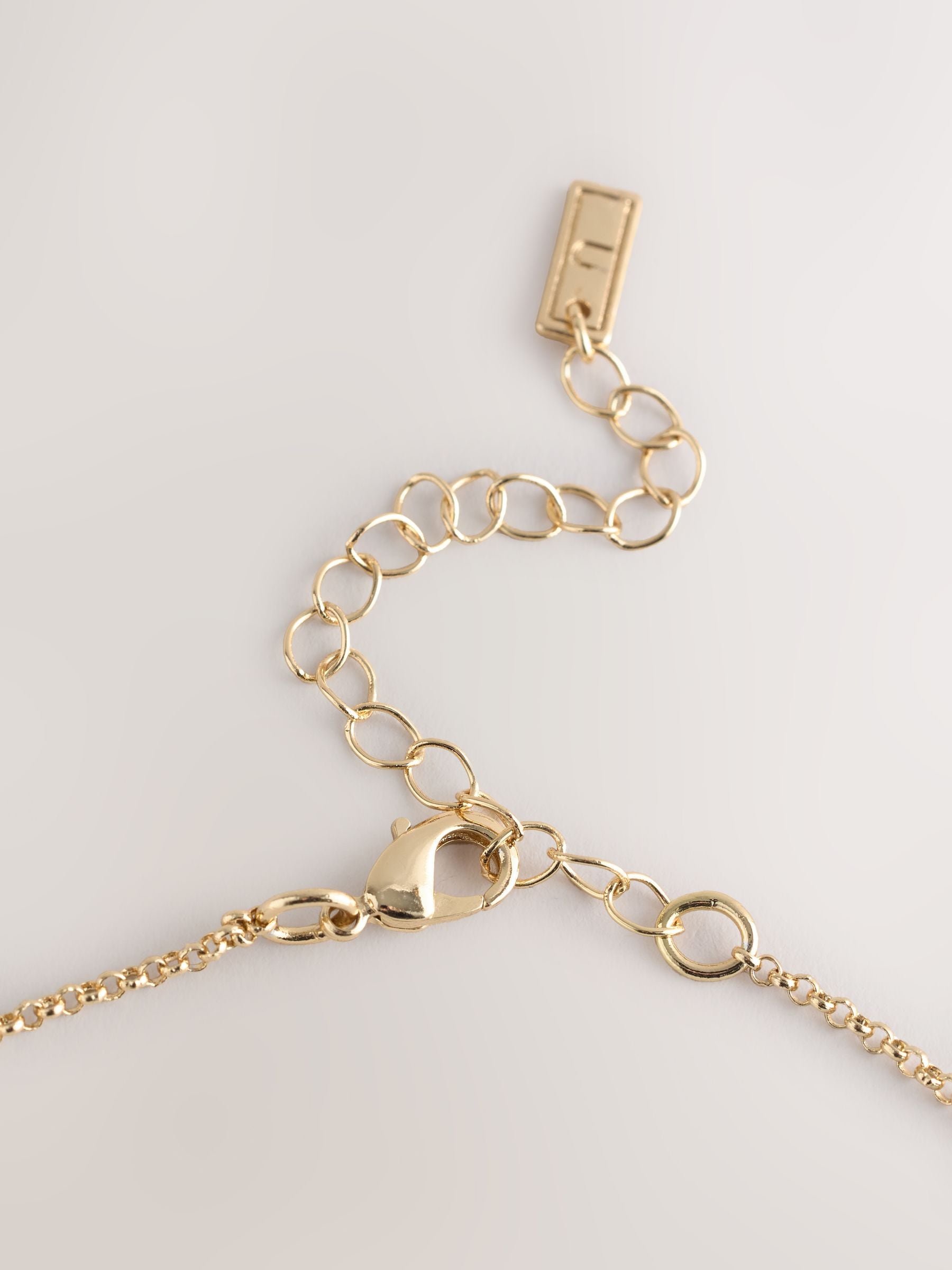 Gold tone etched pendant necklace, imported from the UK