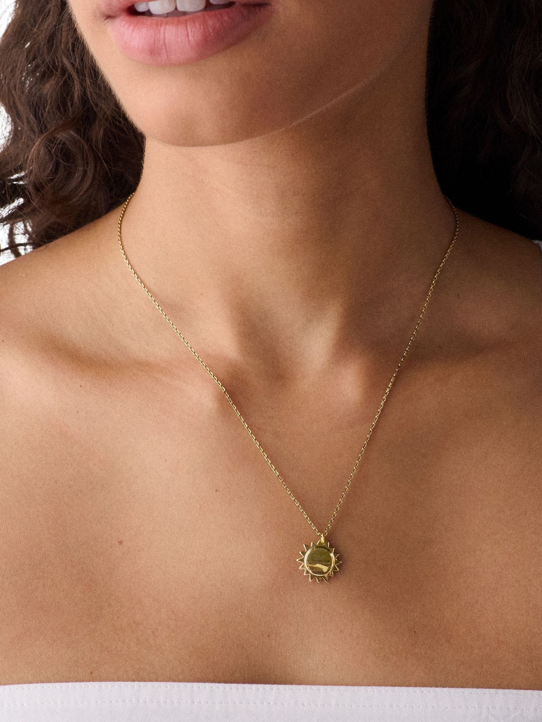 Kate Spade gold tone sun pendant necklace, imported from the UK