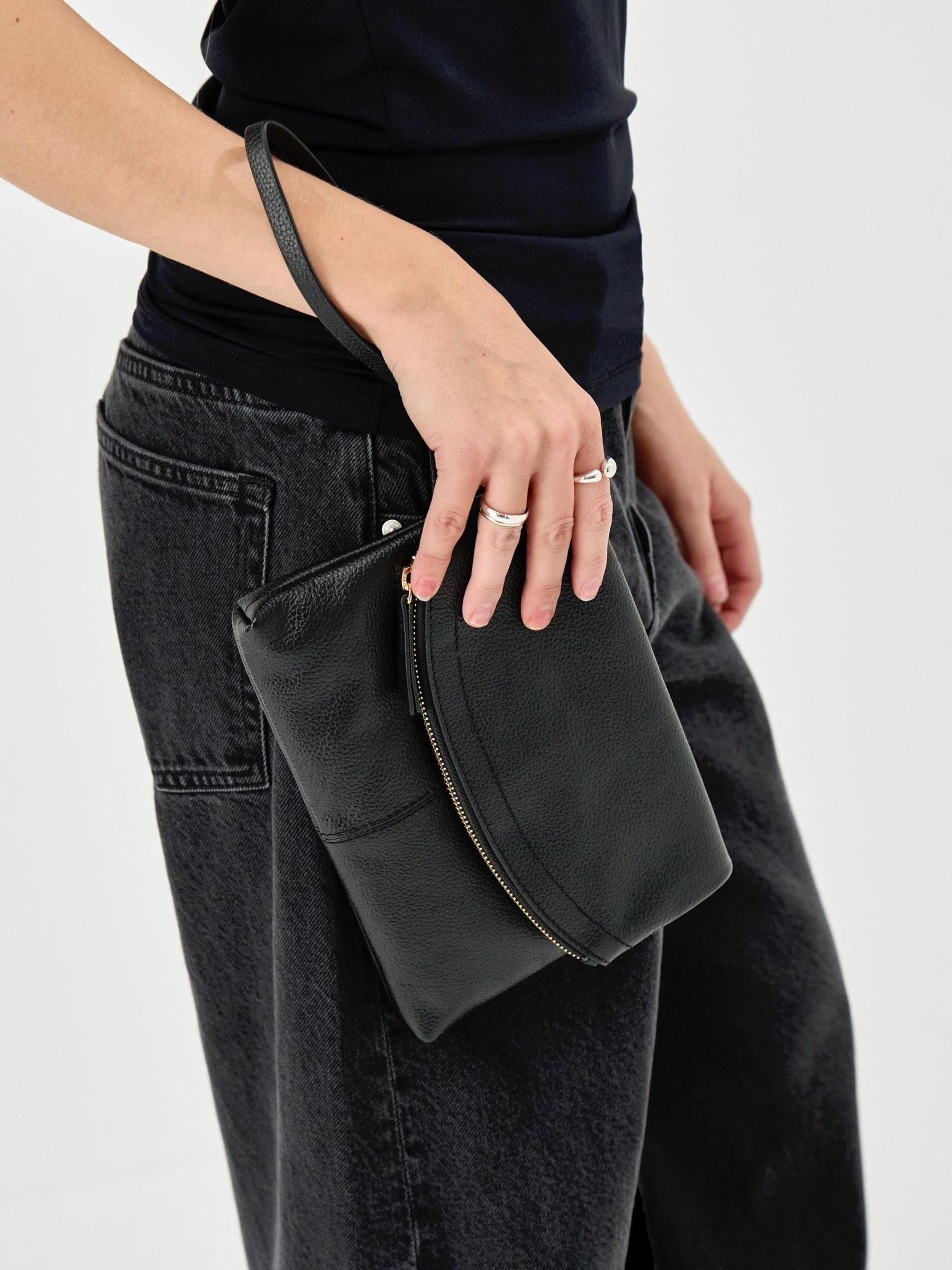 Accessorize black curved foldover leather wristlet bag, imported from the UK