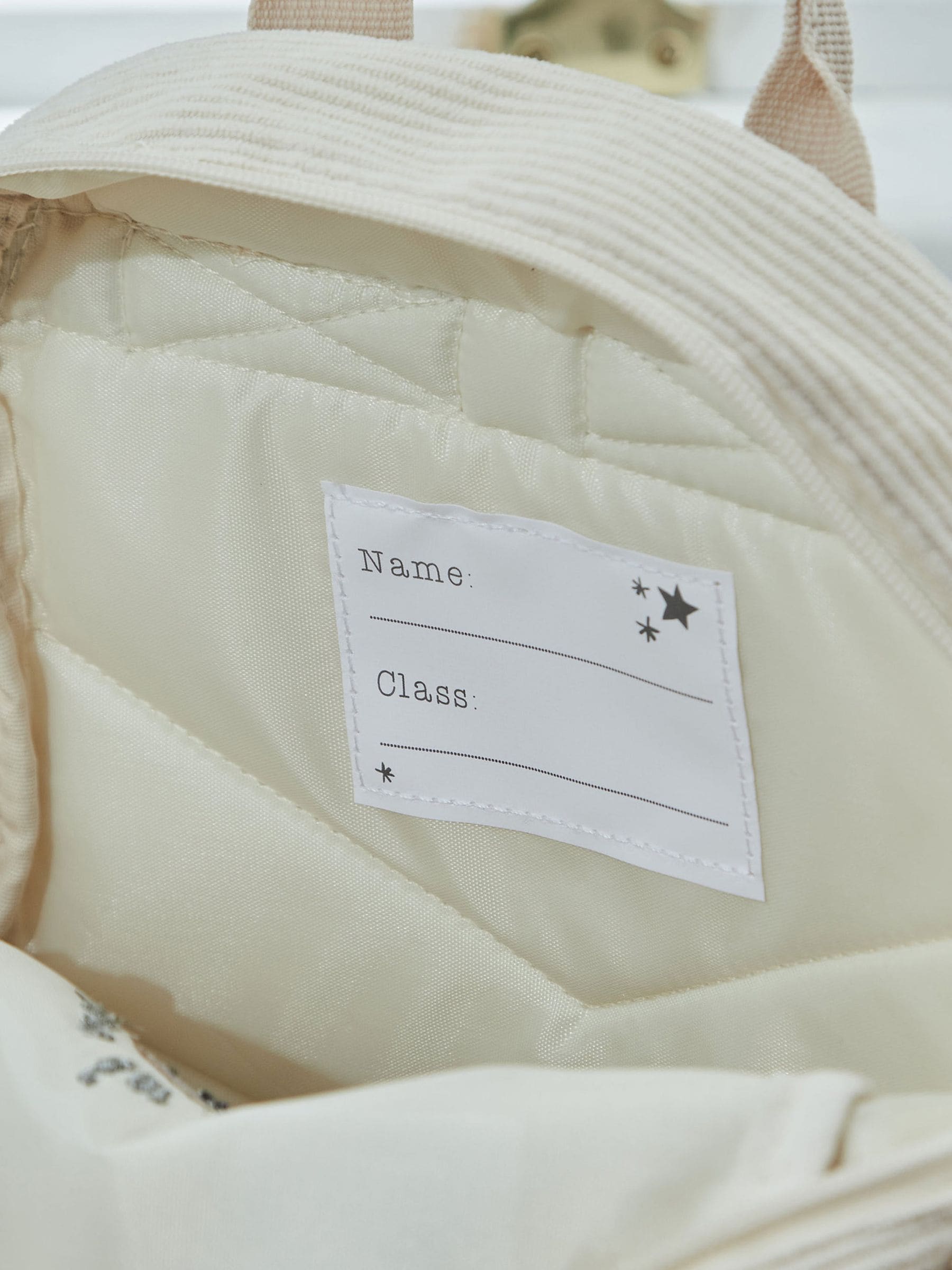 My 1st Years ecru cord backpack with croissant embroidery (British brand)