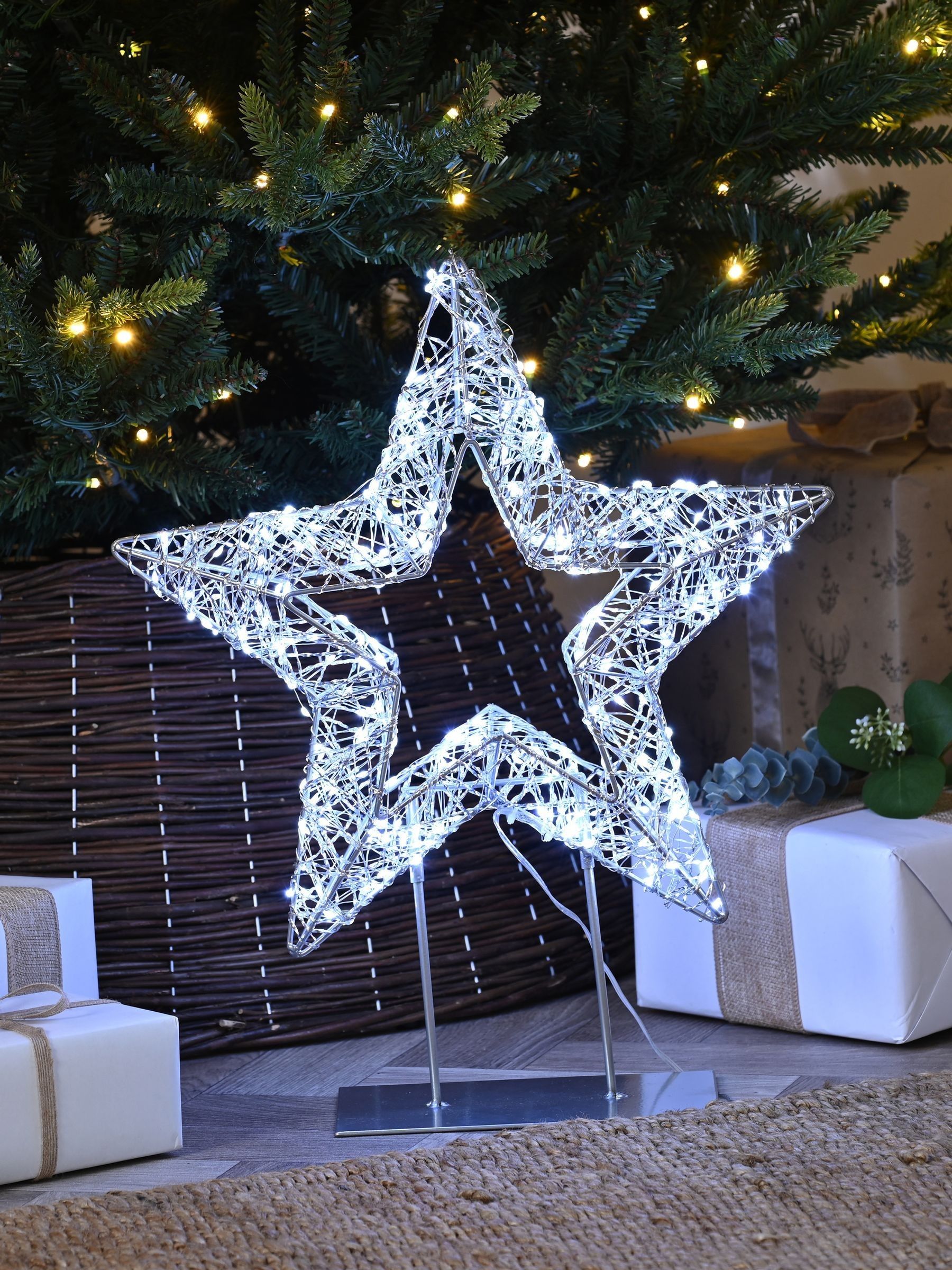 Festive 45cm lit silver shimmer star on stand with white LEDs, imported from the UK