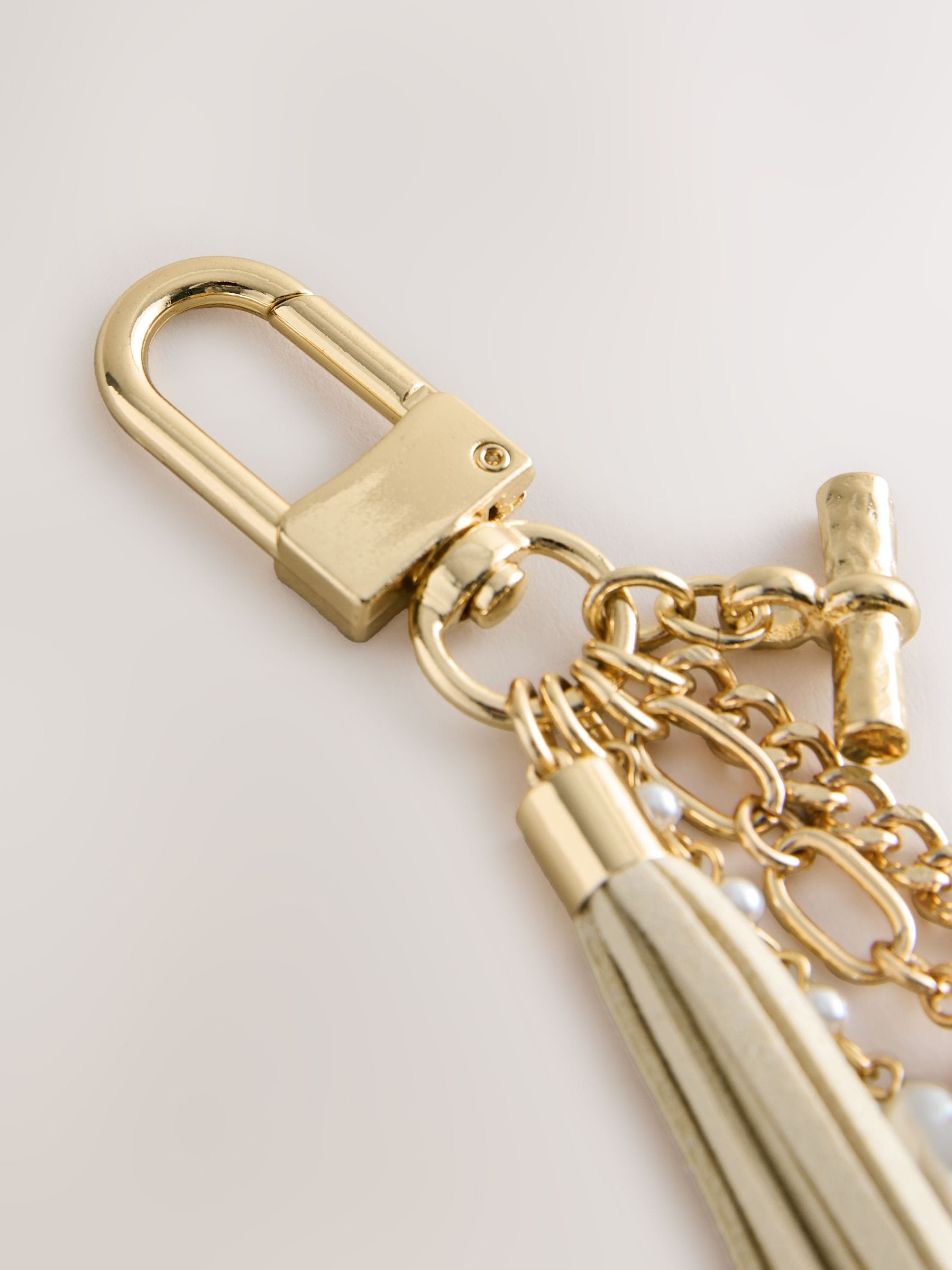 Gold beaded shell bag charm with tassel and pearls, imported from UK