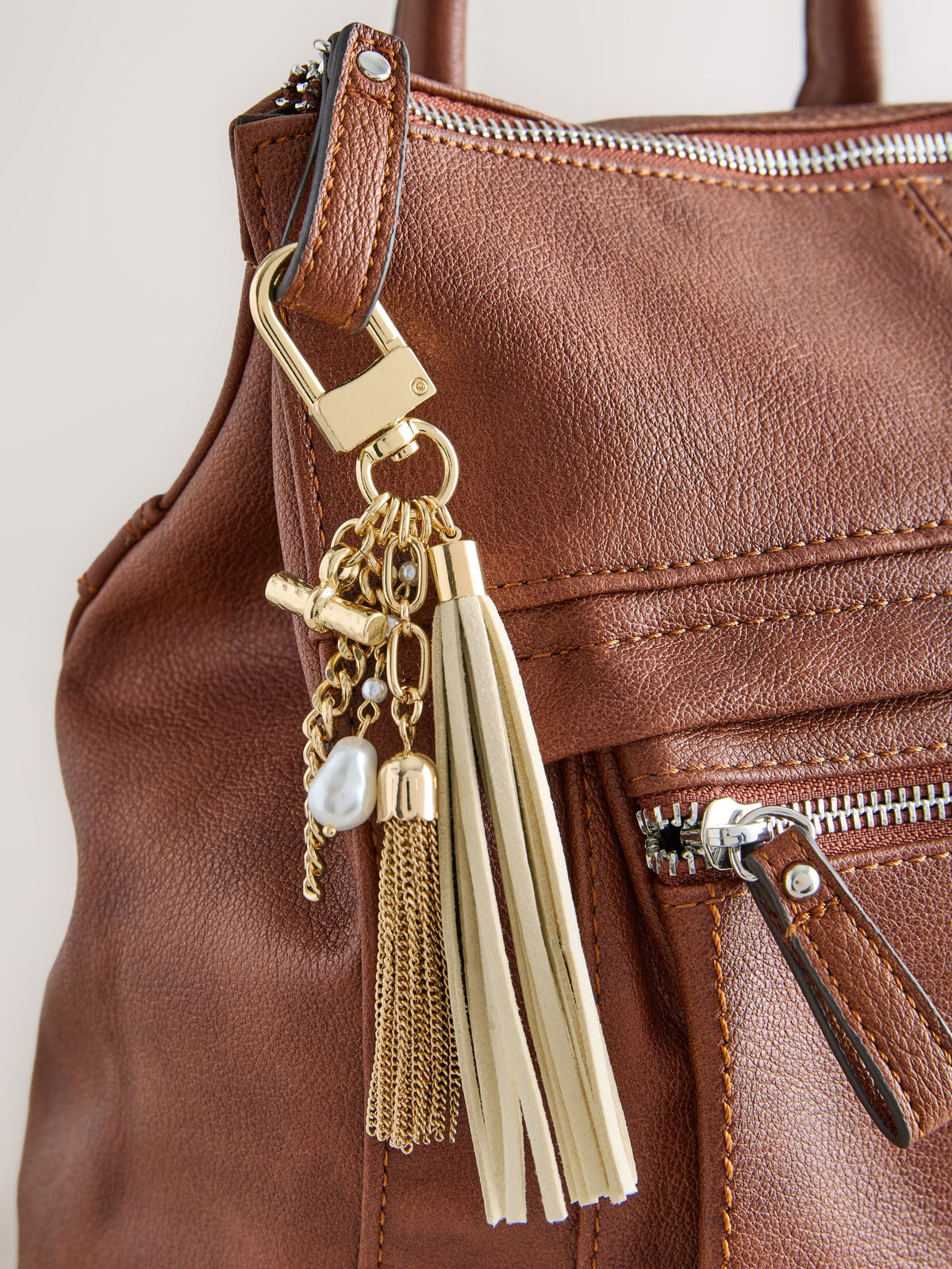 Gold beaded shell bag charm with tassel and pearls, imported from UK