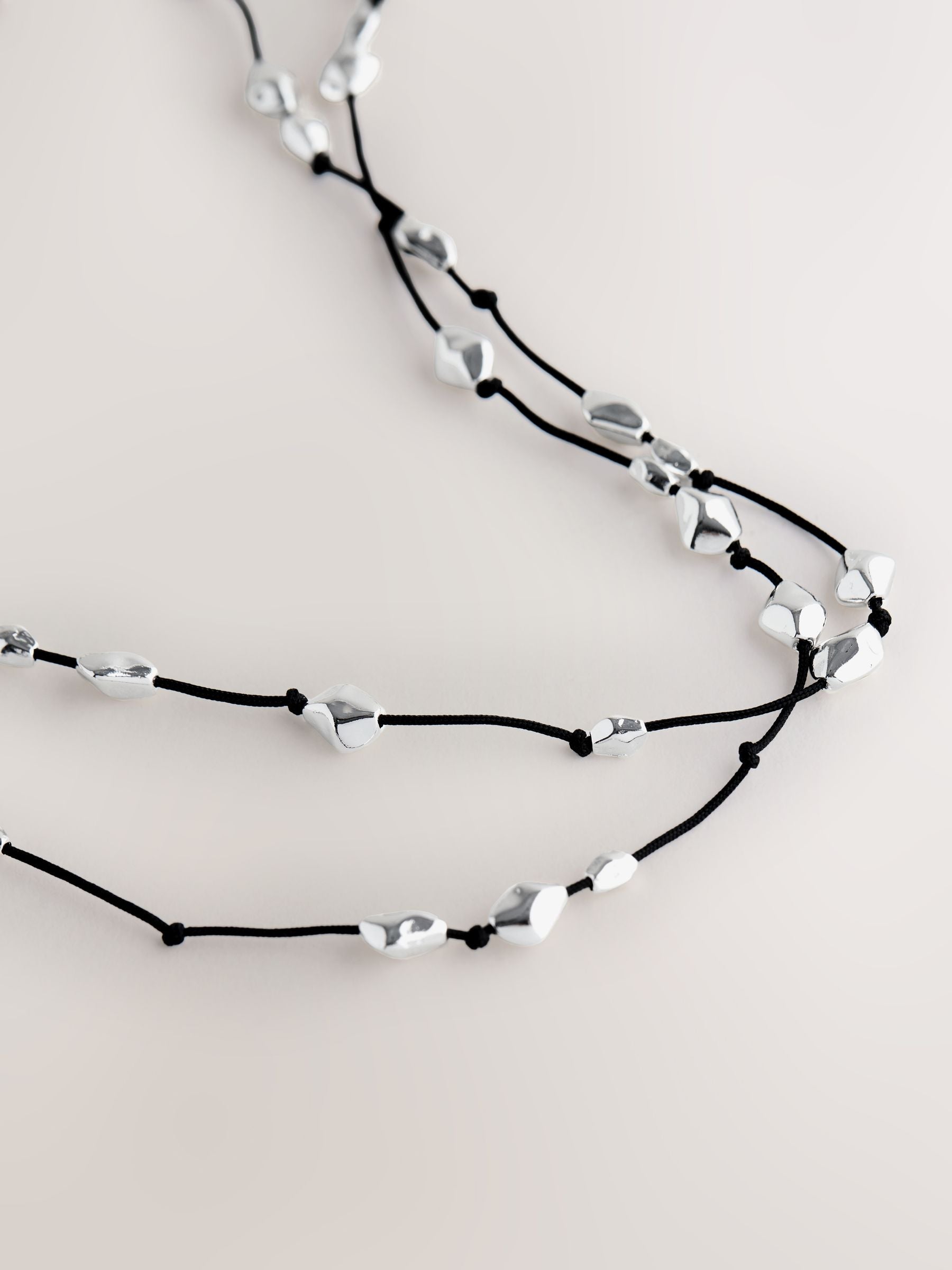 Silver tone beaded cord long necklace (British brand)