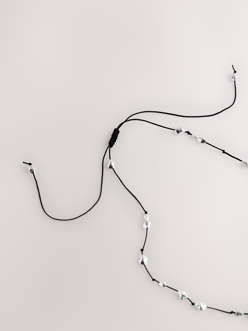 Silver tone beaded cord long necklace (British brand)