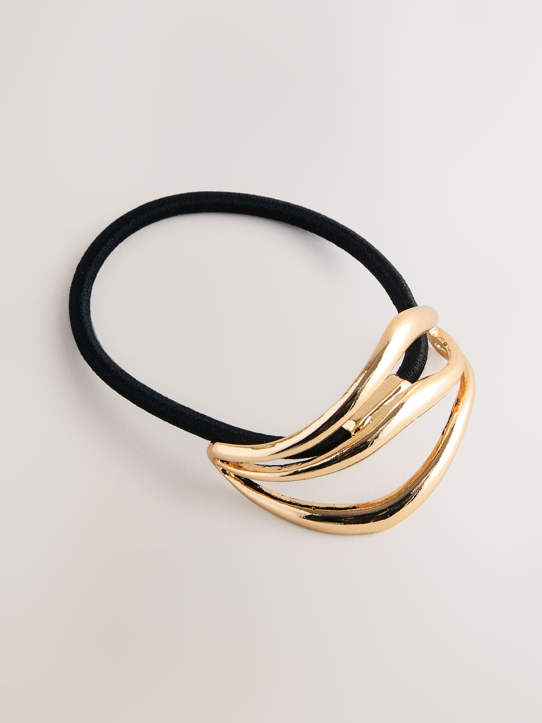 Gold tone metal hair bobble with sculptural design, UK version