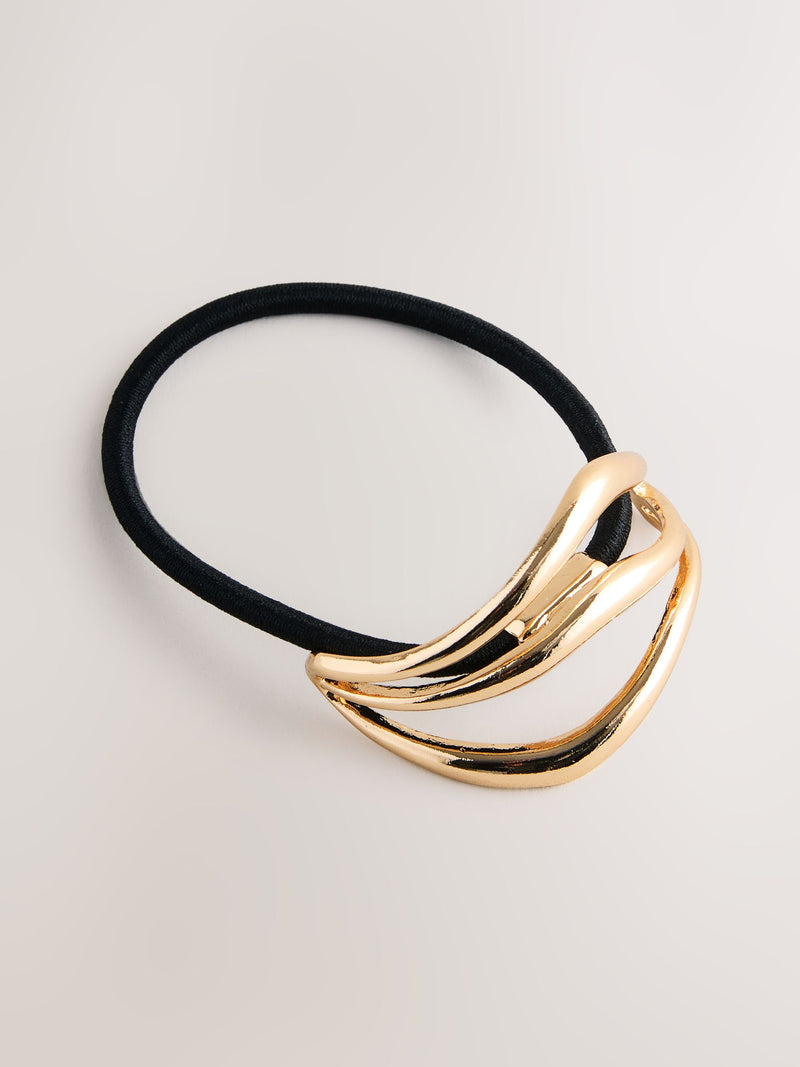 Gold tone metal hair bobble with sculptural design, UK version
