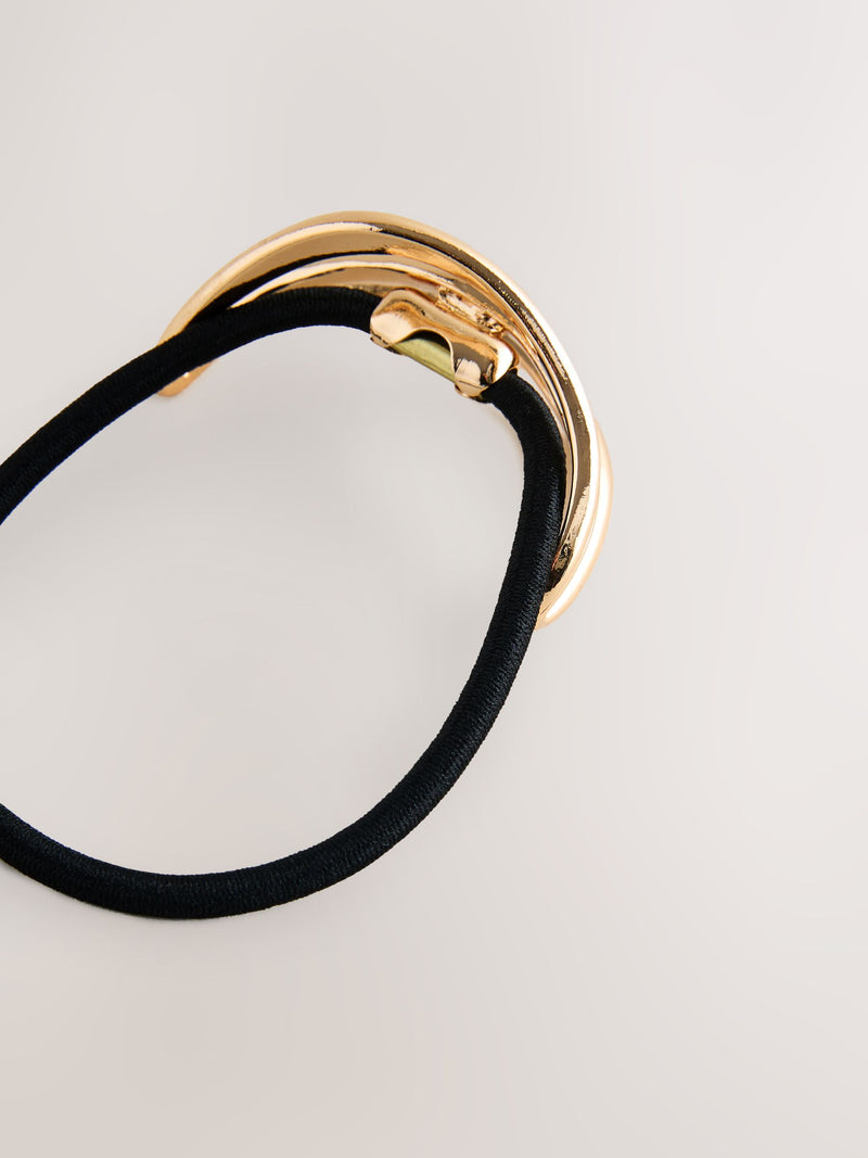 Gold tone metal hair bobble with sculptural design, UK version