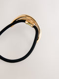 Gold tone metal hair bobble with sculptural design, UK version