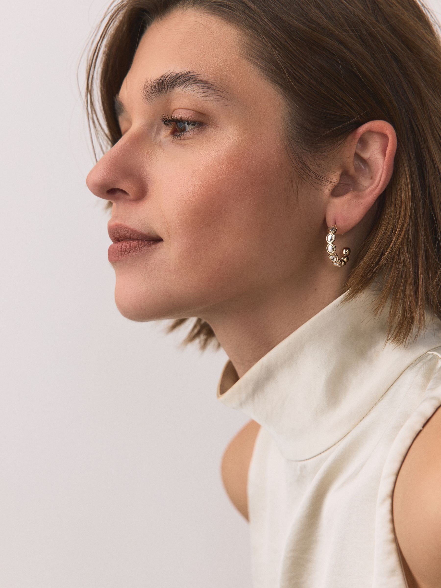 Silver tone mixed metal hoop earrings, imported from the UK