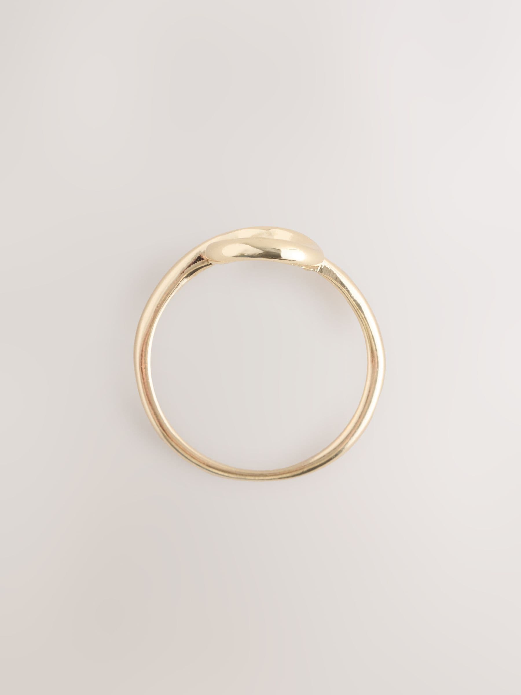 Gold tone cross over ring made from recycled zinc (British brand)