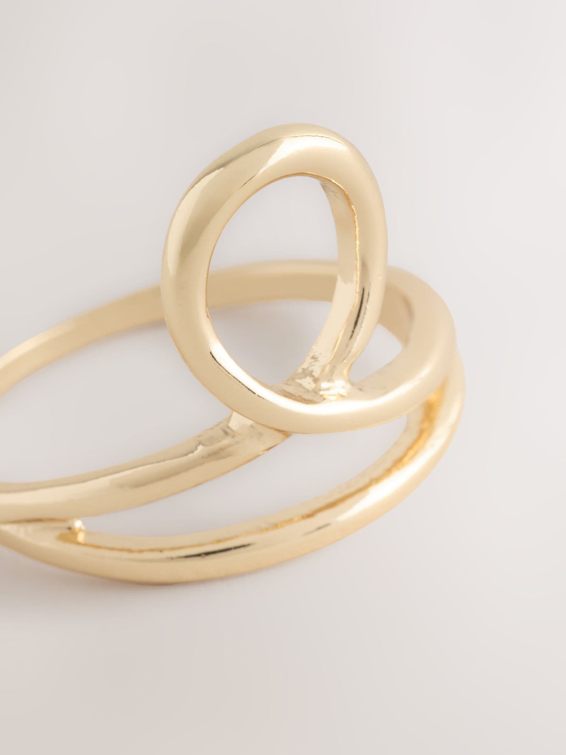 Gold tone cross over ring made from recycled zinc (British brand)