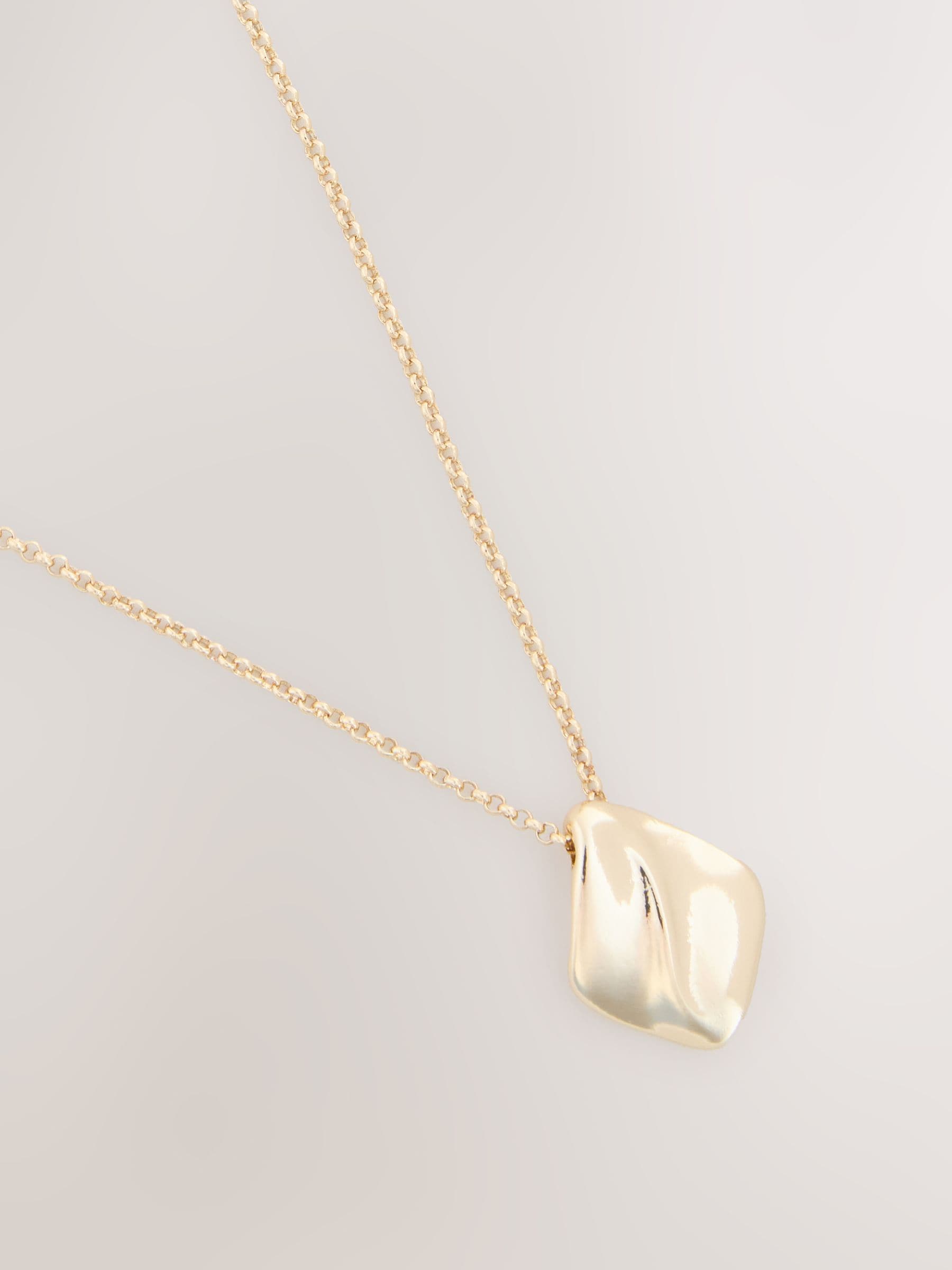 Gold tone organic pendant necklace with recycled metal, UK version