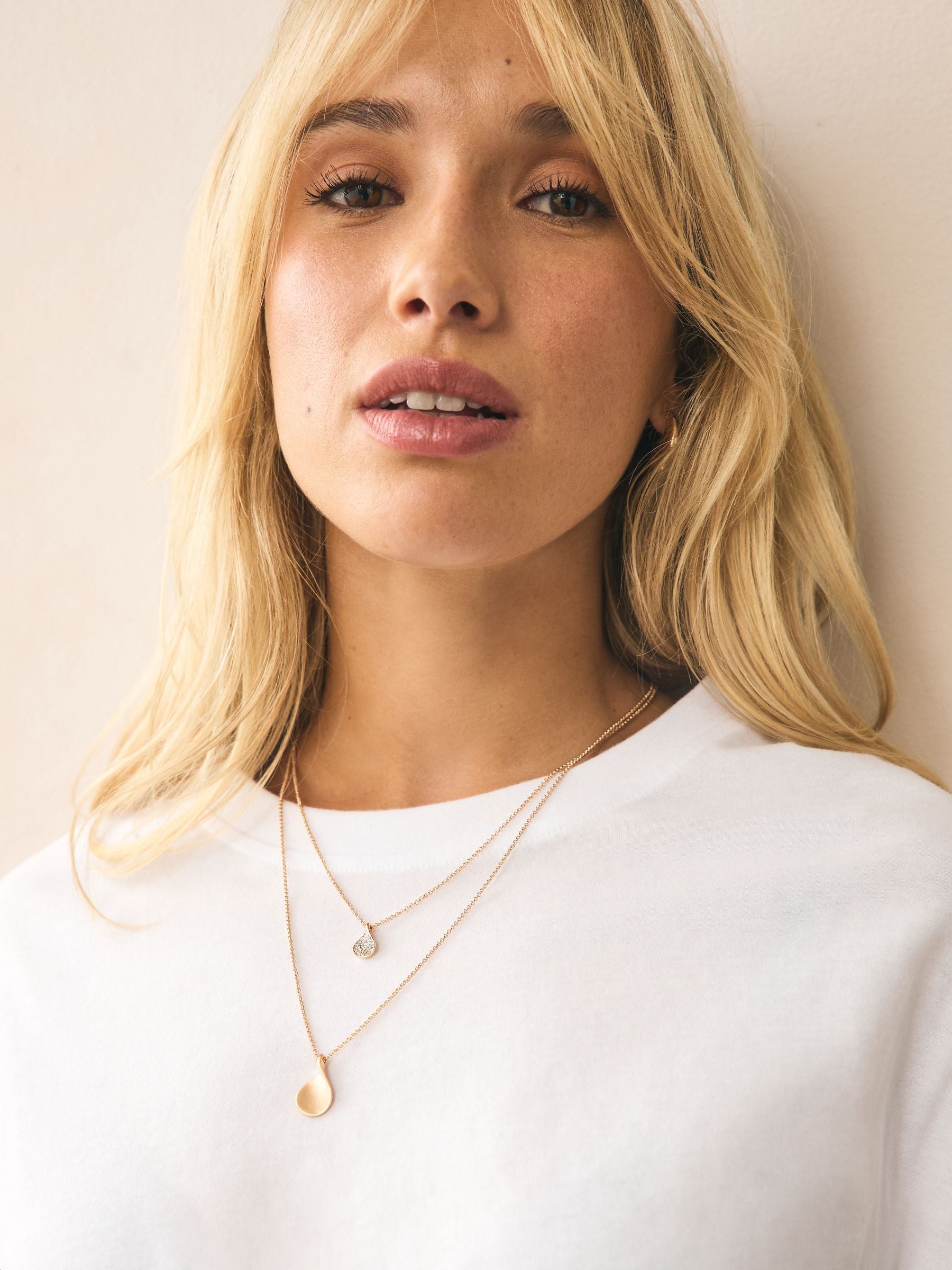 Gold tone layered necklace with sparkling and plain pendants, imported from the UK