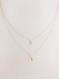 Gold tone layered necklace with sparkling and plain pendants, imported from the UK
