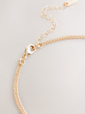 Gold tone layered necklace with sparkling and plain pendants, imported from the UK