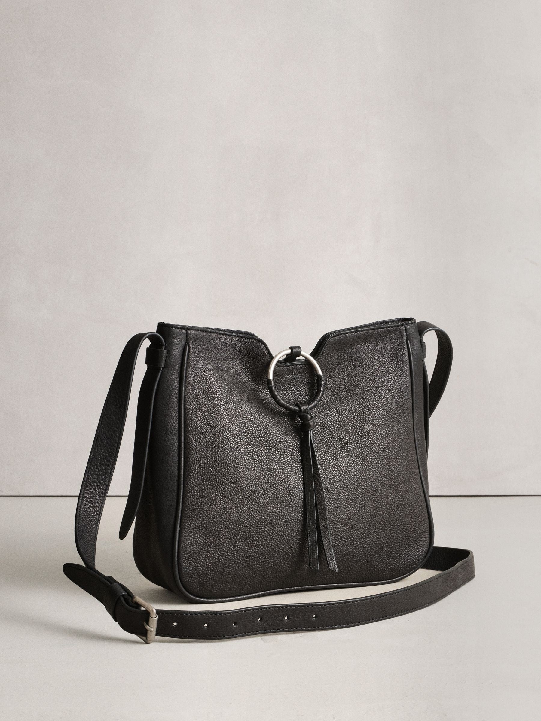 Black leather messenger bag with cross-body strap, UK version