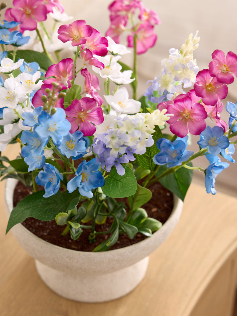 Multi bright artificial florals in ceramic bowl, imported from the UK