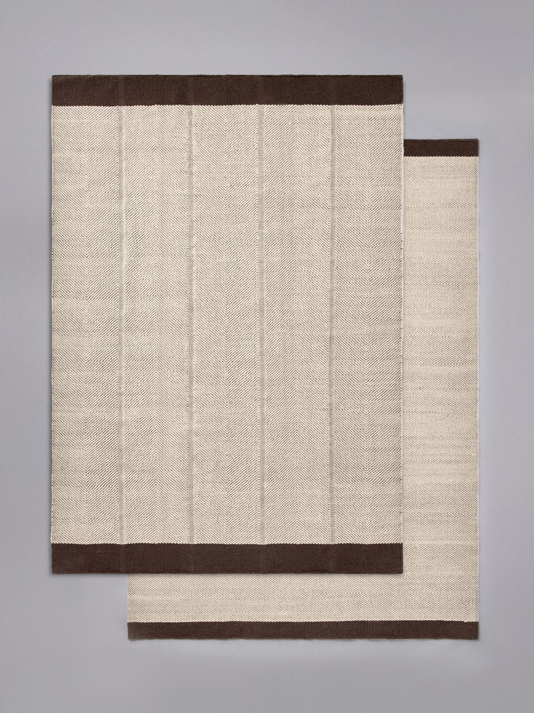 The Set 2 pack cotton herringbone flatweave rugs, imported from the UK