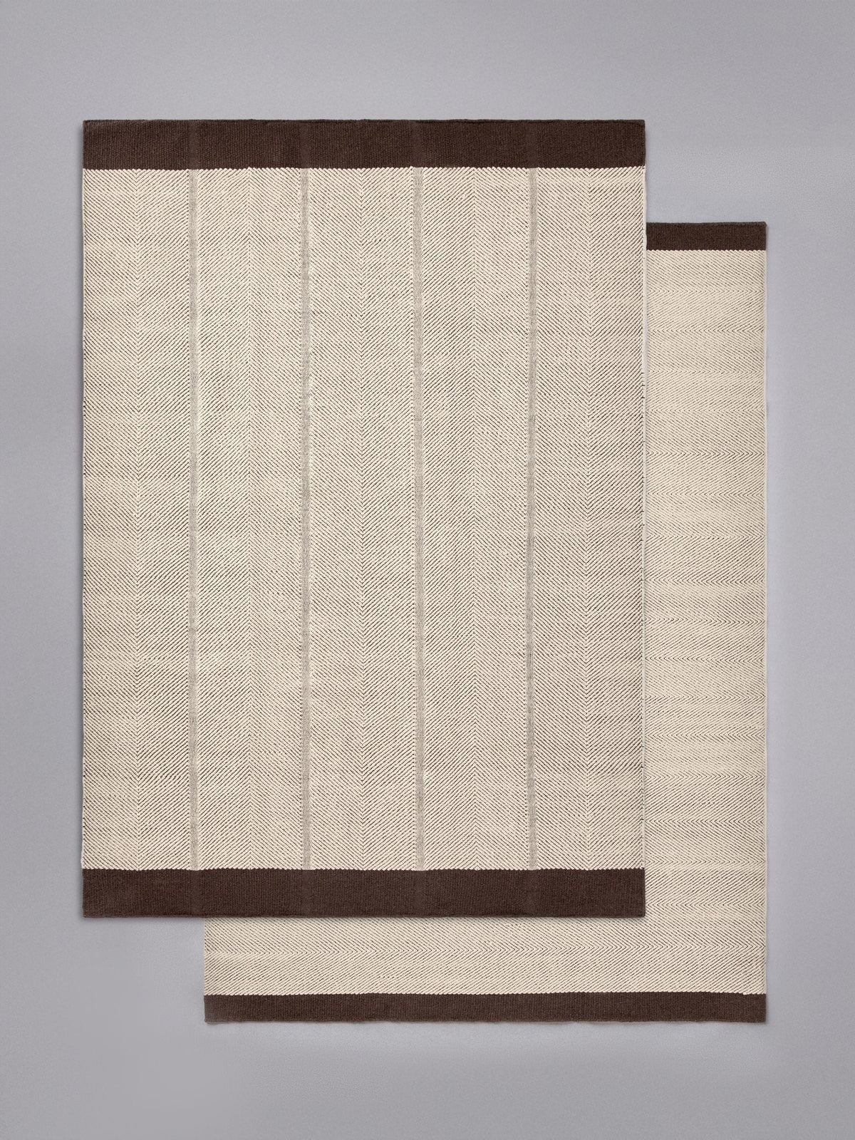 The Set 2 pack cotton herringbone flatweave rugs, imported from the UK