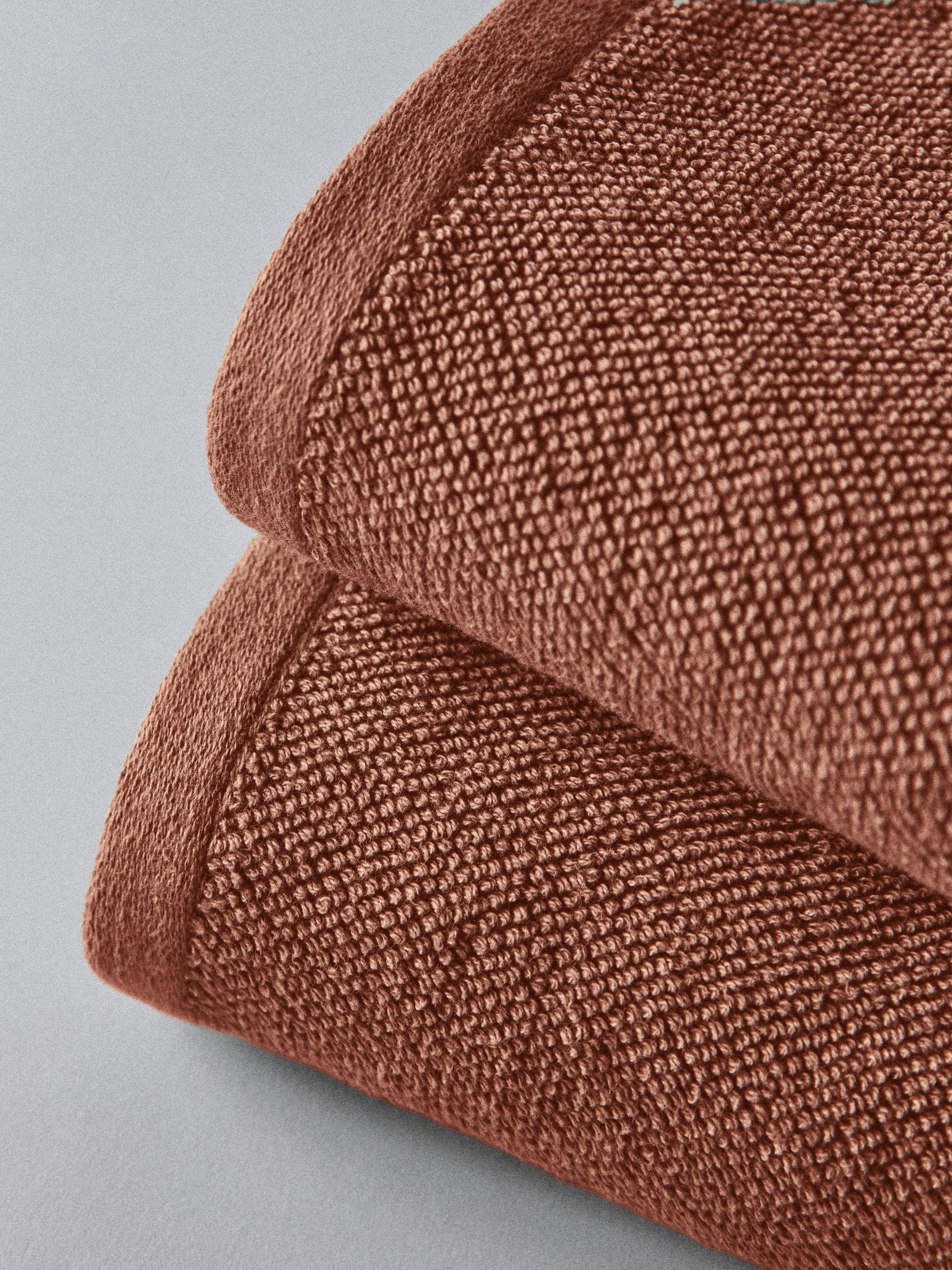 The Set rust popcorn textured 100% cotton bath towels, imported from the UK