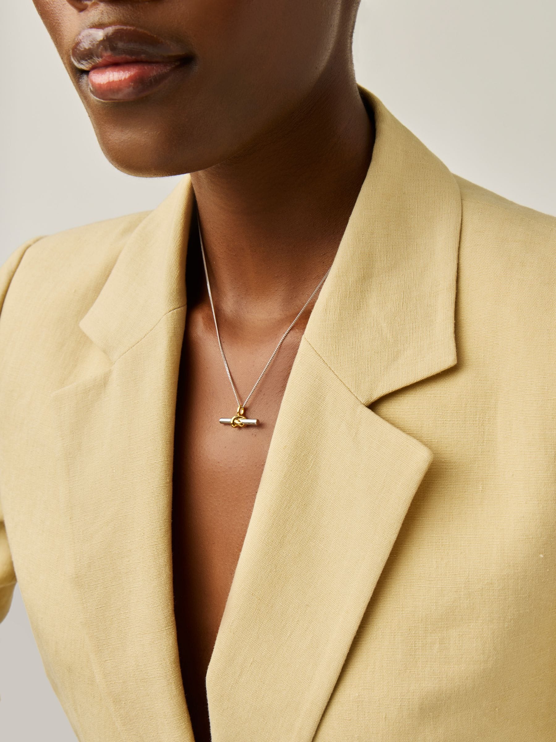 Missoma gold tone T-bar knot pendant necklace, imported from the UK