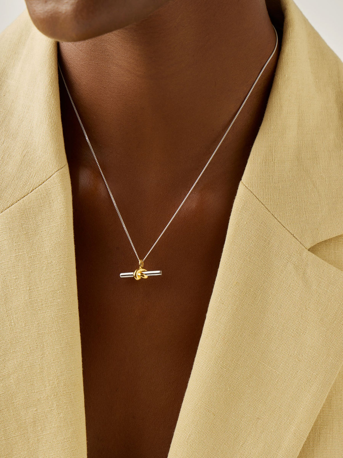 Missoma gold tone T-bar knot pendant necklace, imported from the UK