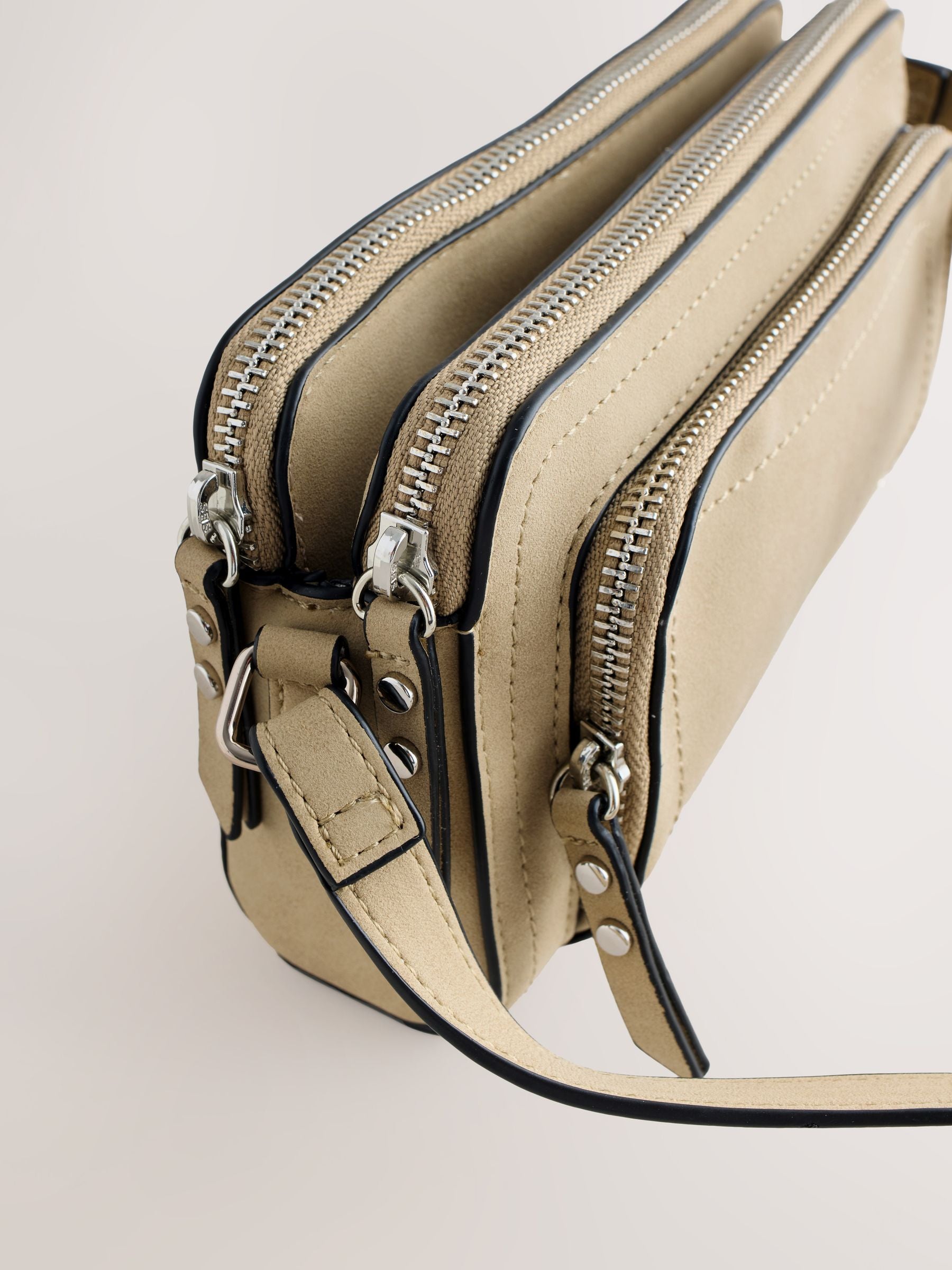 Stone double zip cross-body bag in faux suede, imported from the UK