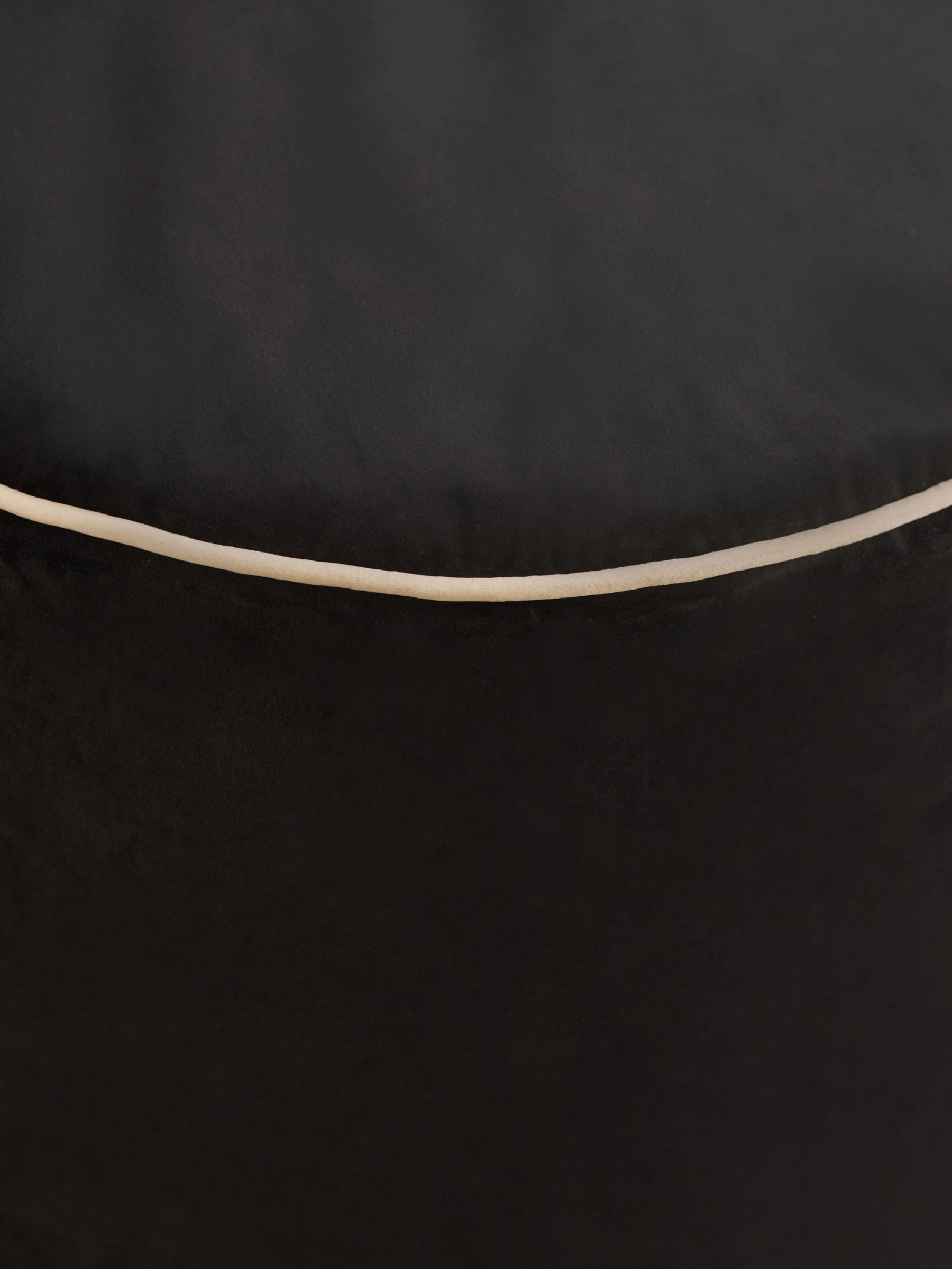 Black velvet pouffe with contrast piping, British brand