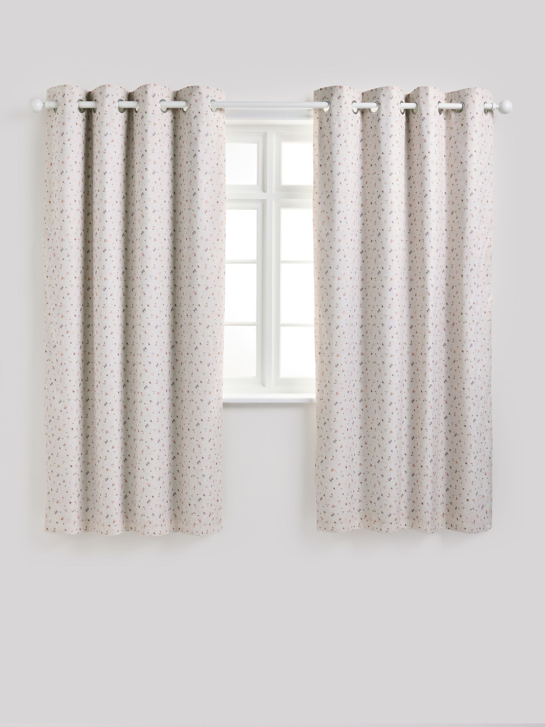 Pink ditsy eyelet blackout curtains, imported from the UK