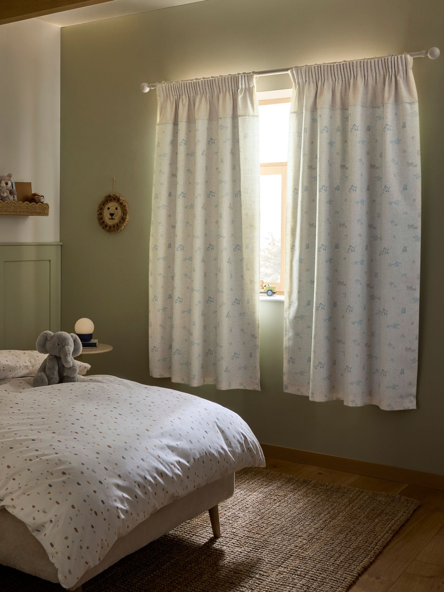 Neutral Mini Jungle pencil pleat blackout curtains imported from the UK