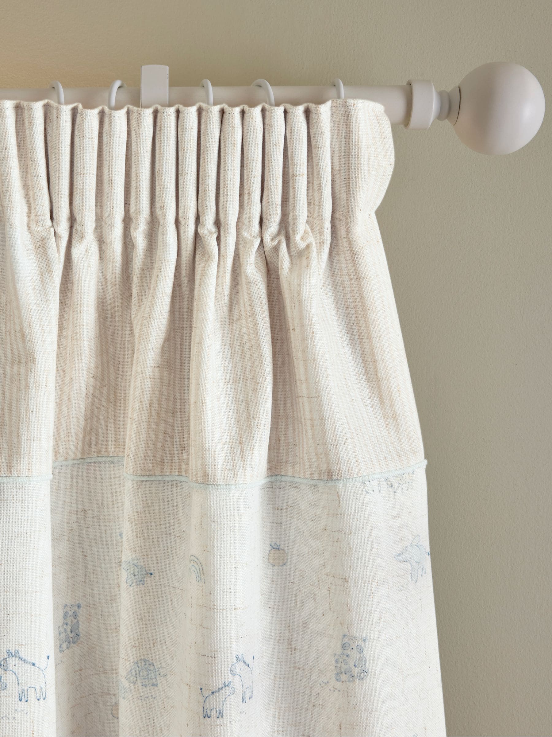 Neutral Mini Jungle pencil pleat blackout curtains imported from the UK