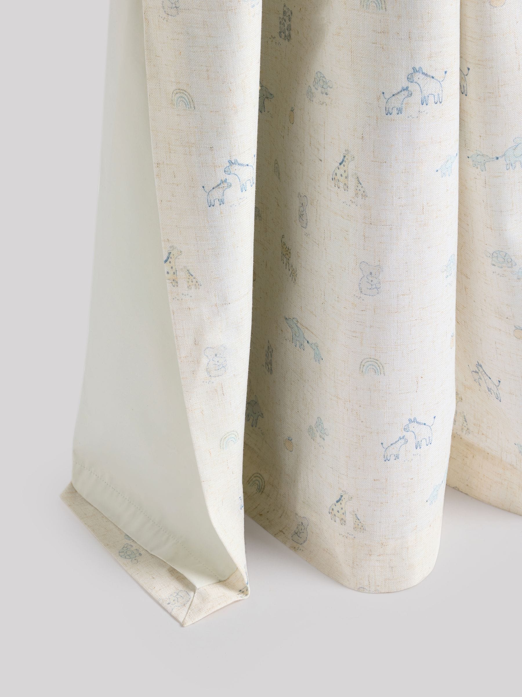 Neutral Mini Jungle pencil pleat blackout curtains imported from the UK