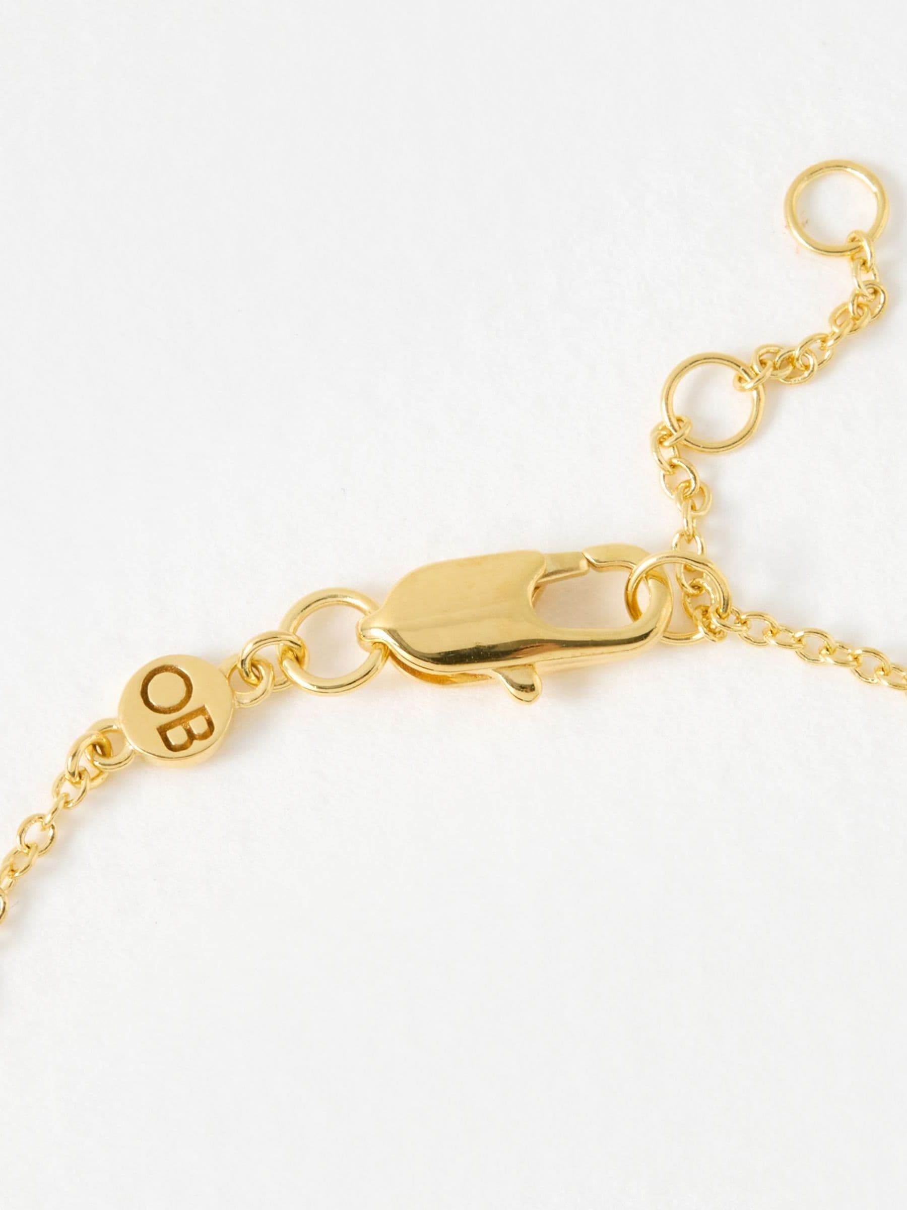 Oliver Bonas gold tone paw print charm bracelet, imported from the UK