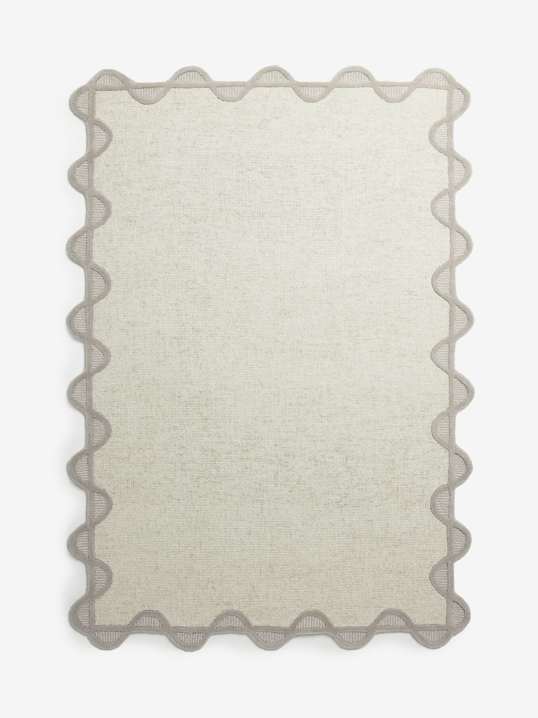 Natural scallop edge wool rug, imported from the UK