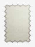 Natural scallop edge wool rug, imported from the UK