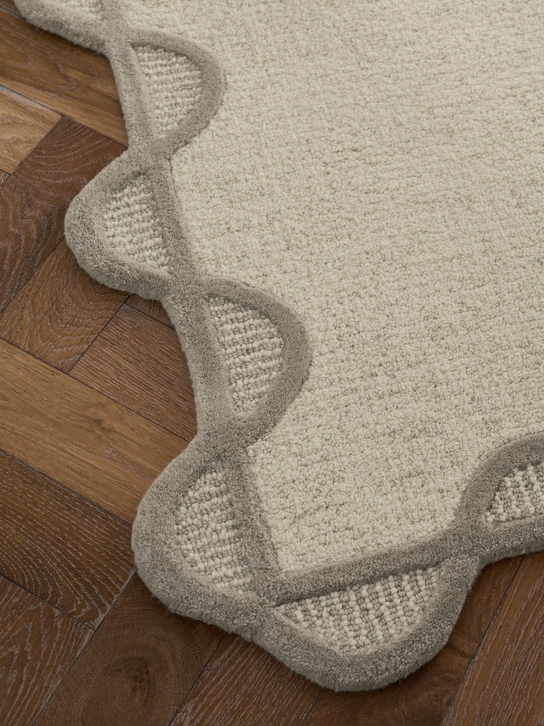 Natural scallop edge wool rug, imported from the UK