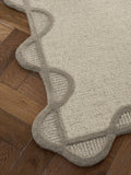 Natural scallop edge wool rug, imported from the UK