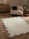 Natural scallop edge wool rug, imported from the UK