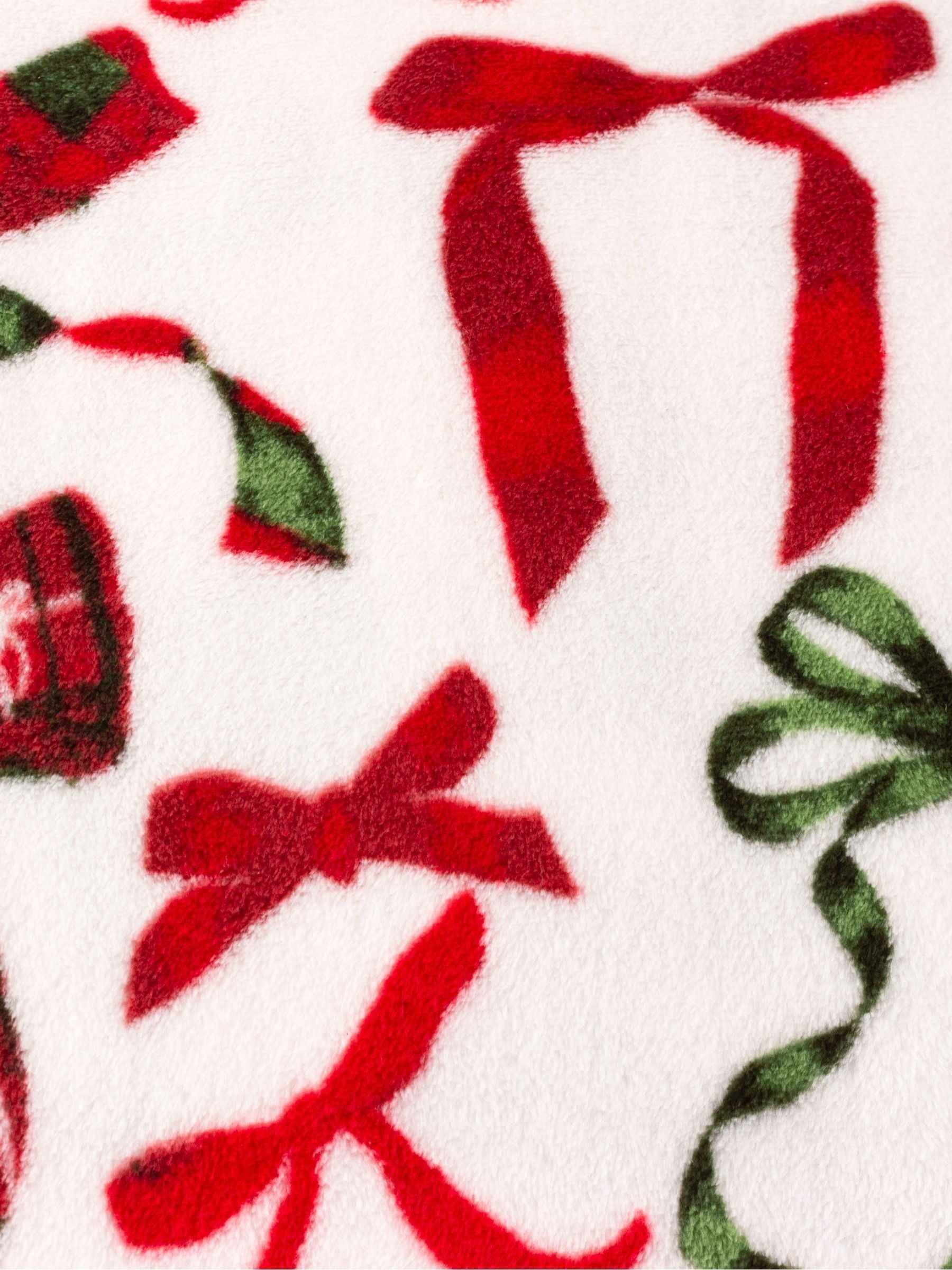 Furn festive fleece throw with bow design, imported from the UK