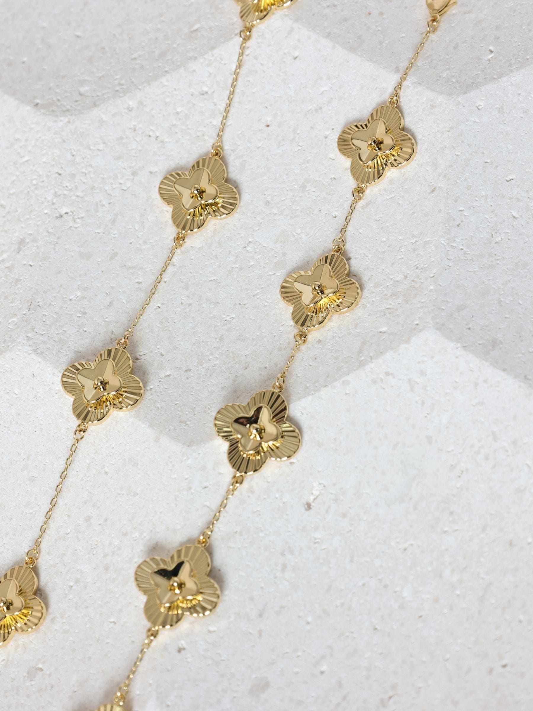 Inicio gold tone diamond cut clover station bracelet, UK version