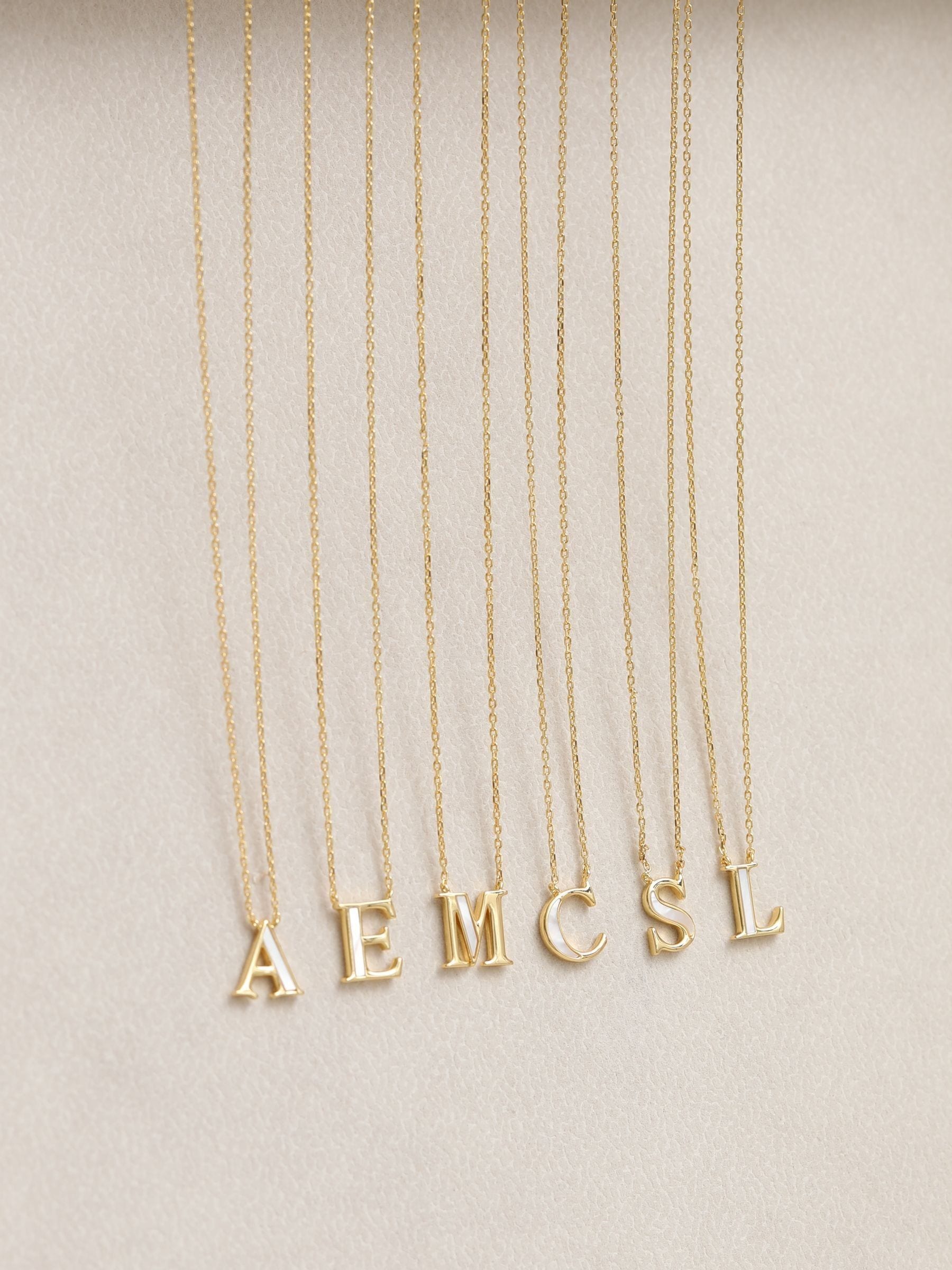 Inicio M initial pendant with mother of pearl and 17-inch chain, UK version