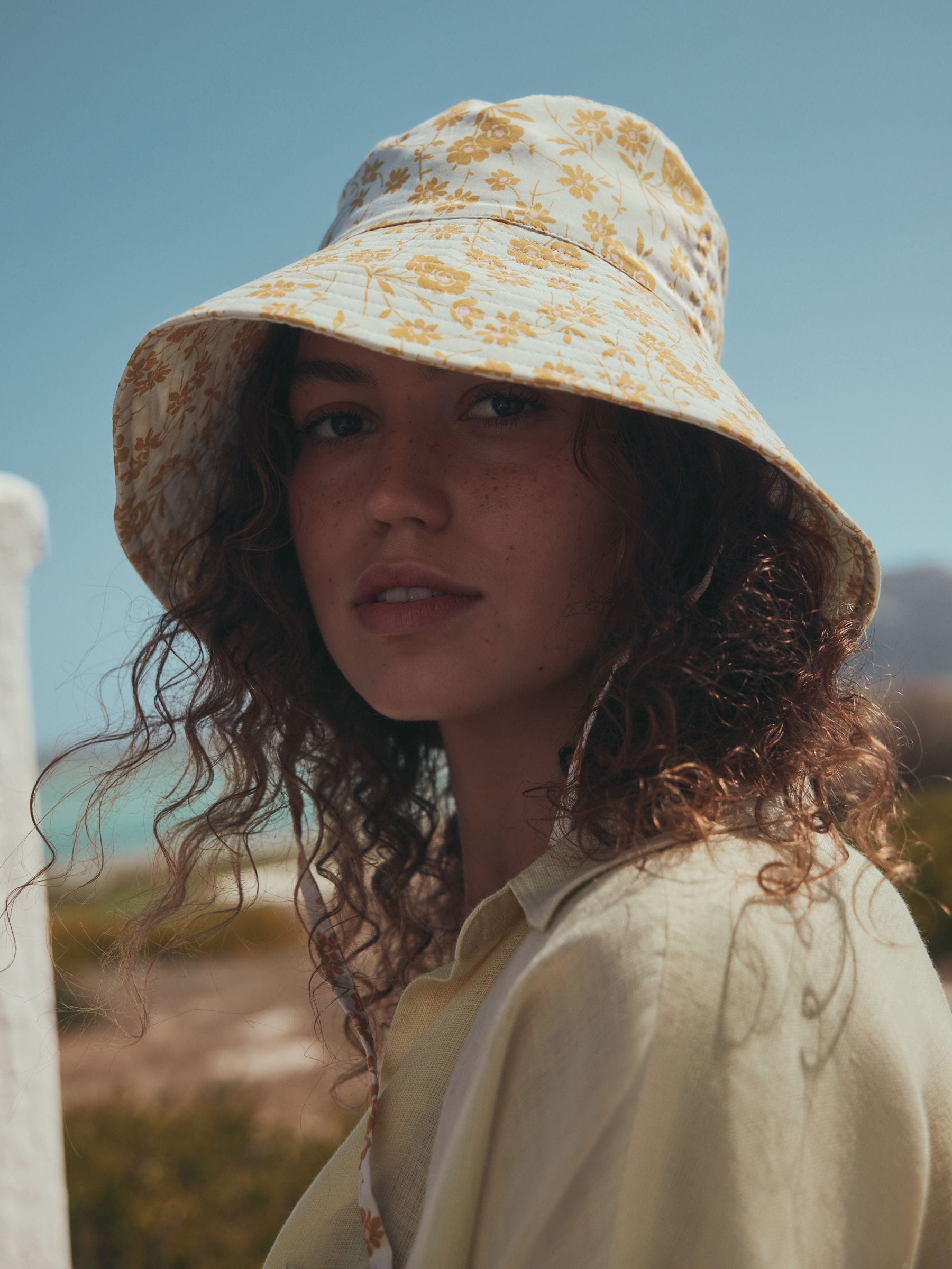 Orange floral oversized bucket hat made from 100% cotton - British product