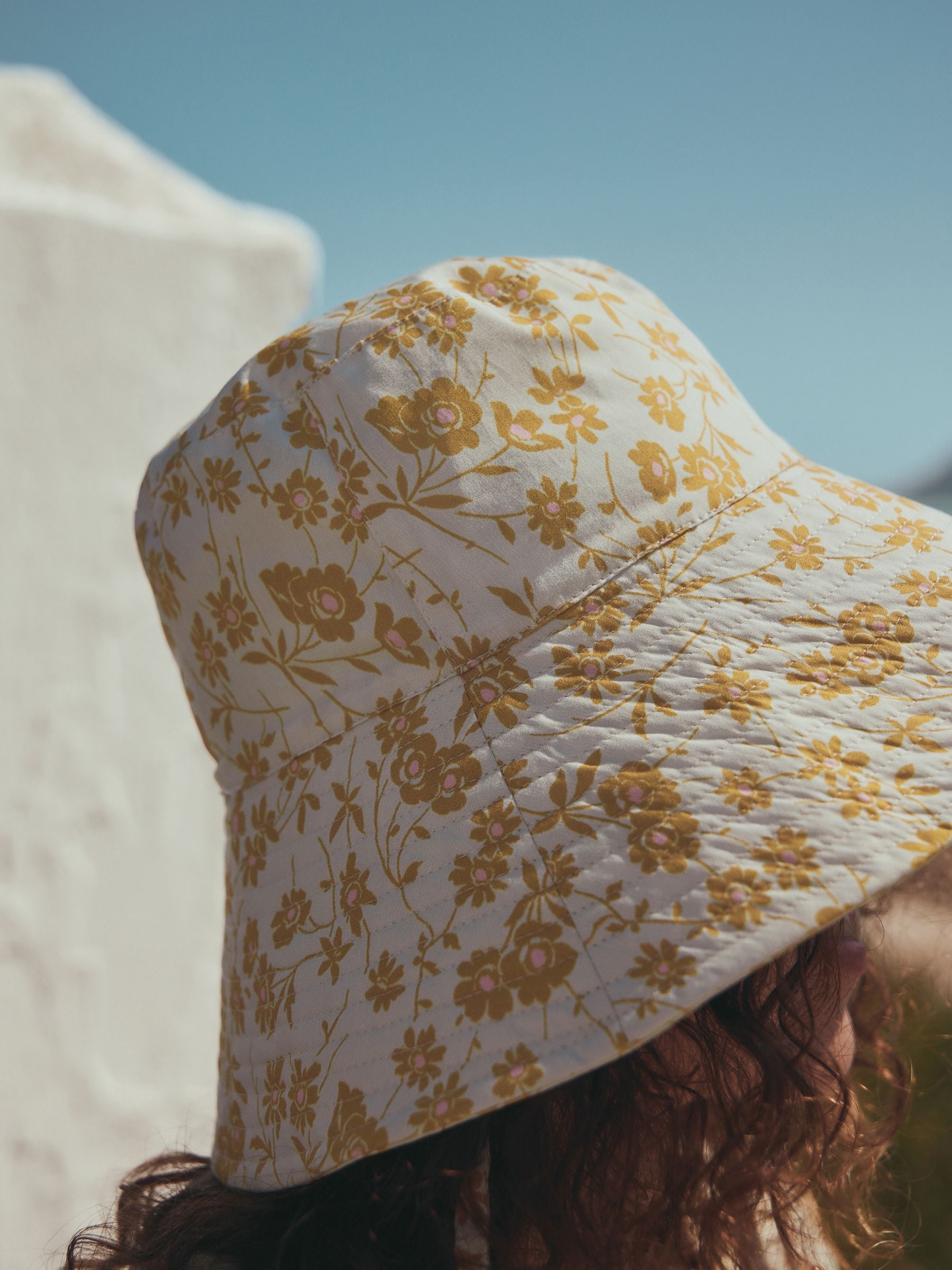 Orange floral oversized bucket hat made from 100% cotton - British product