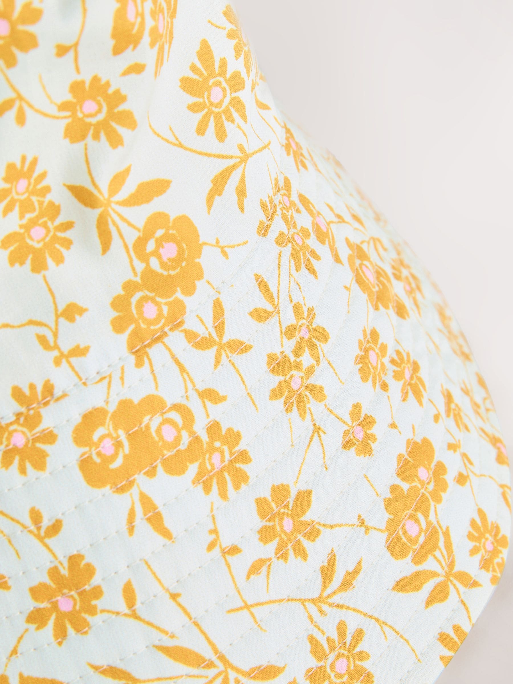 Orange floral oversized bucket hat made from 100% cotton - British product