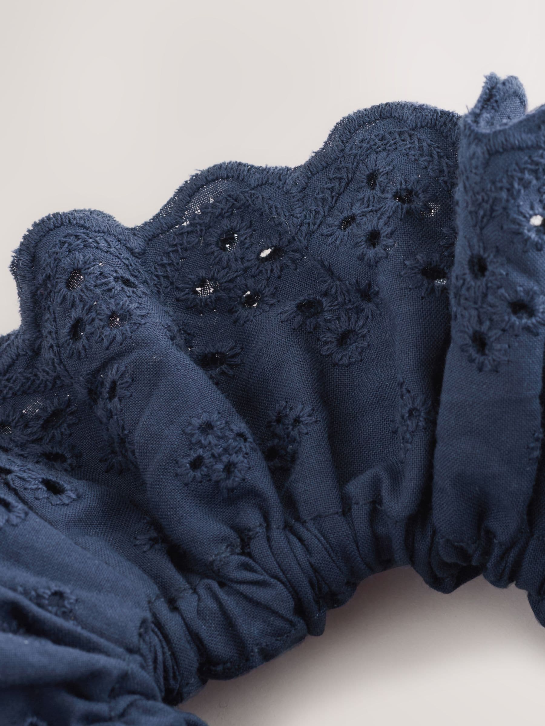 Navy broderie scrunchie with eyelet embroidery, imported from the UK