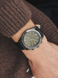 Black N. leather strap watch with green checkerboard dial, UK version