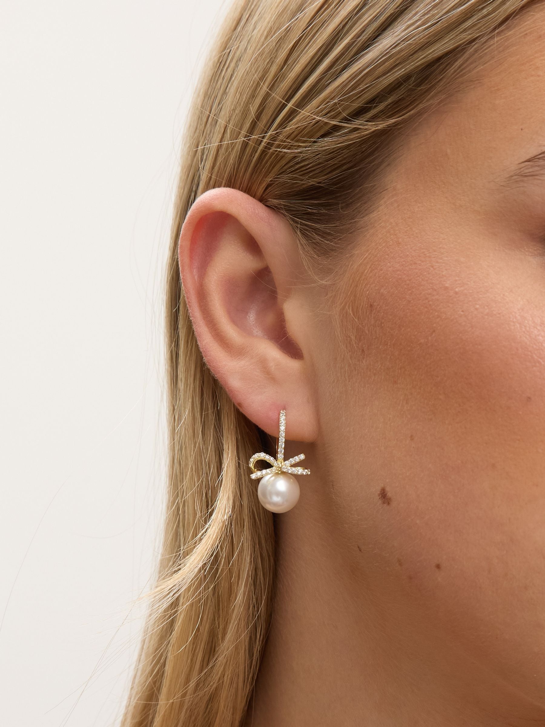 Jon Richard gold plated crystal bow and pearl hoop earrings, UK version