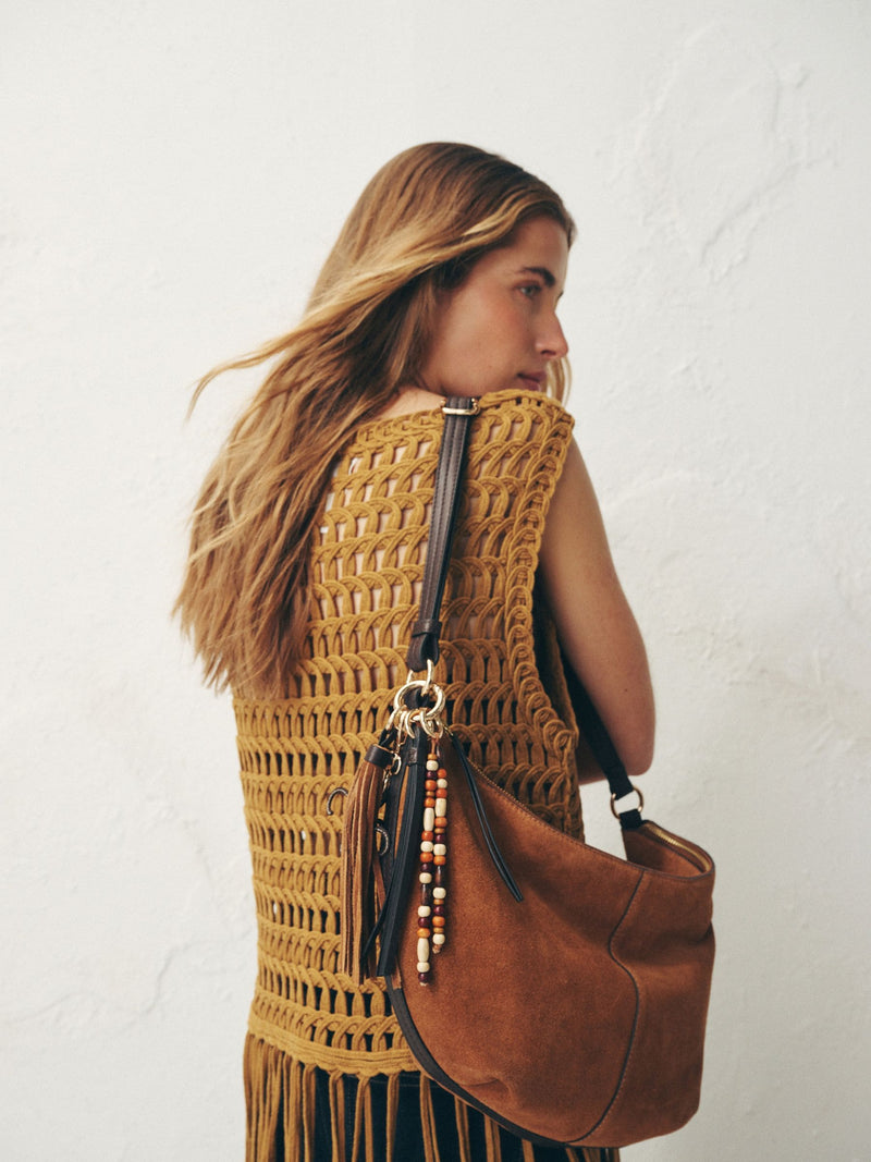 Tan brown suede charm sling bag with tassel, imported from the UK
